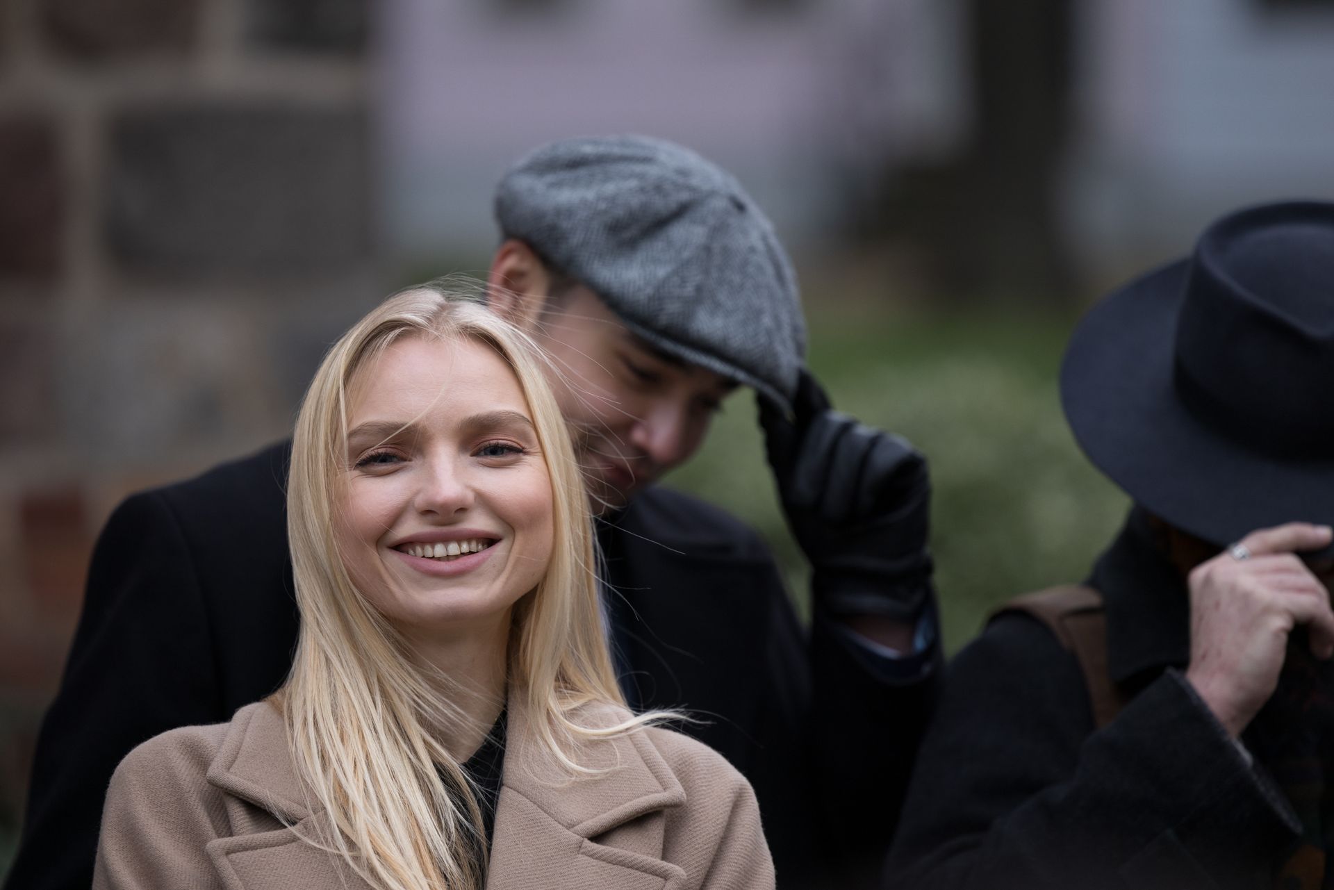 Group of people in outdoor fashion setting with vintage hats in Berlin.