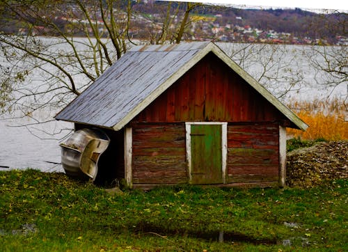 Wooden Shed and Boat by River