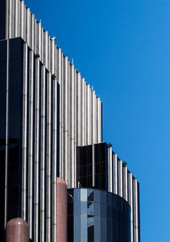 Contemporary skyscraper facade against a clear blue sky in Ciudad de México.