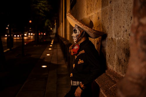 Man in Sombrero and Traditional Clothing at Night
