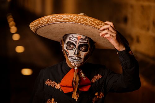 Free A man in traditional attire with face paint celebrating Day of the Dead in Mexico. Stock Photo
