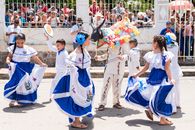 Kids in vibrant traditional outfits perform a cultural dance in Santa Rosa de Lima, El Salvador's festival.