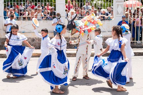 Free Kids in vibrant traditional outfits perform a cultural dance in Santa Rosa de Lima, El Salvador's festival. Stock Photo