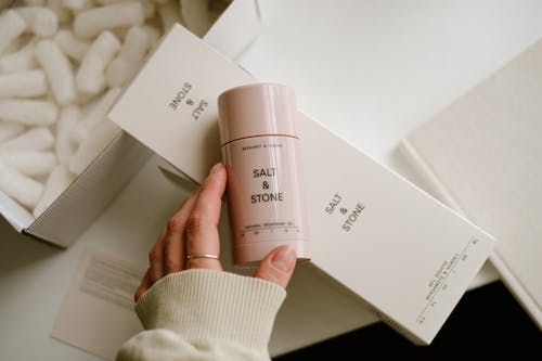 A person holding a box of skin care products