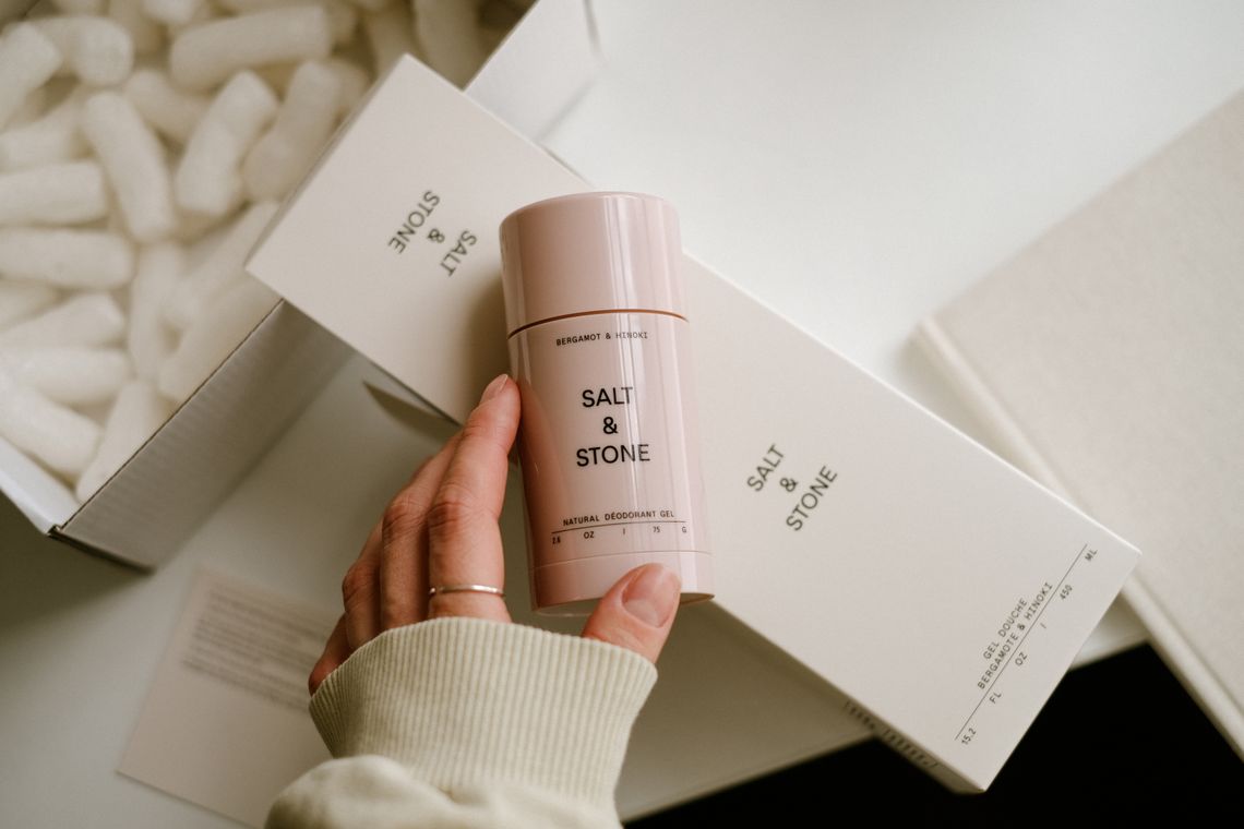 Person holding a carefully packaged box of personal-care products