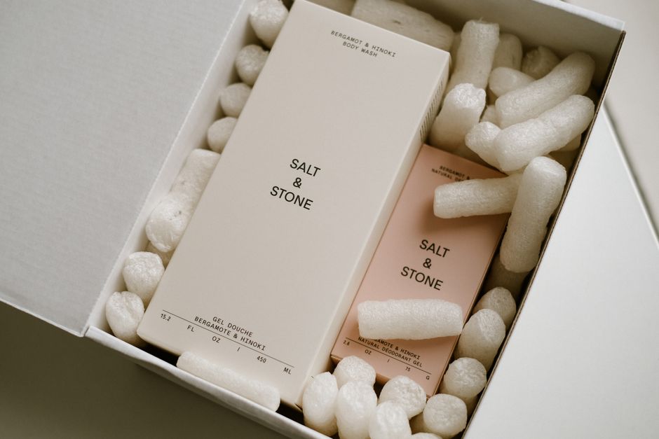 Stylish packaging of Salt & Stone products with protective packing peanuts.