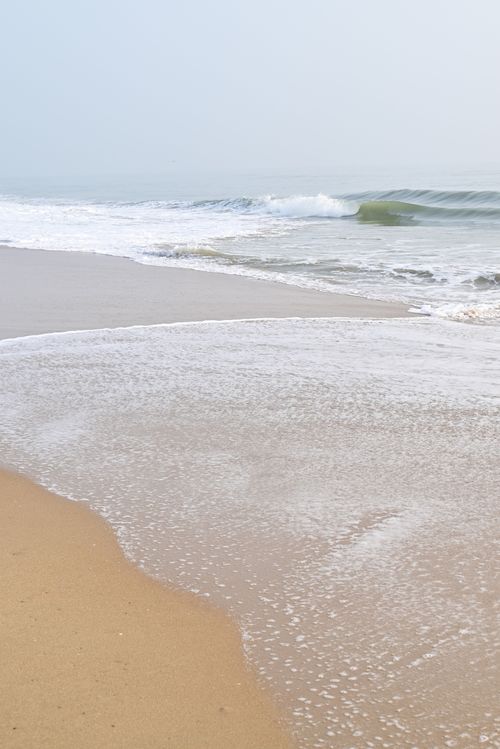 Free Peaceful view of Chennai's beach with gentle waves and sandy shore during the day. Stock Photo