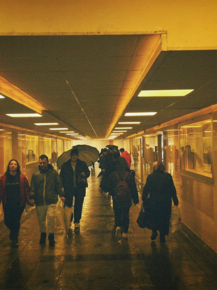 People Walking In Tunnel