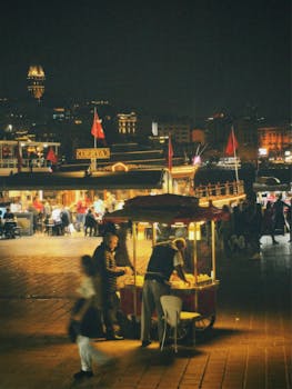 Vibrant street food stall in Istanbul's lively night market, showcasing local culture and illuminated cityscape.