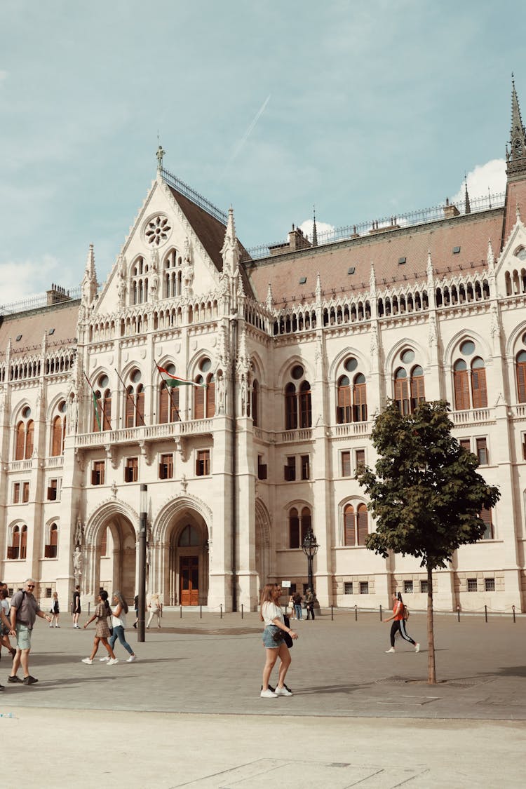 People Walking Near Orszaghaz In Budapest