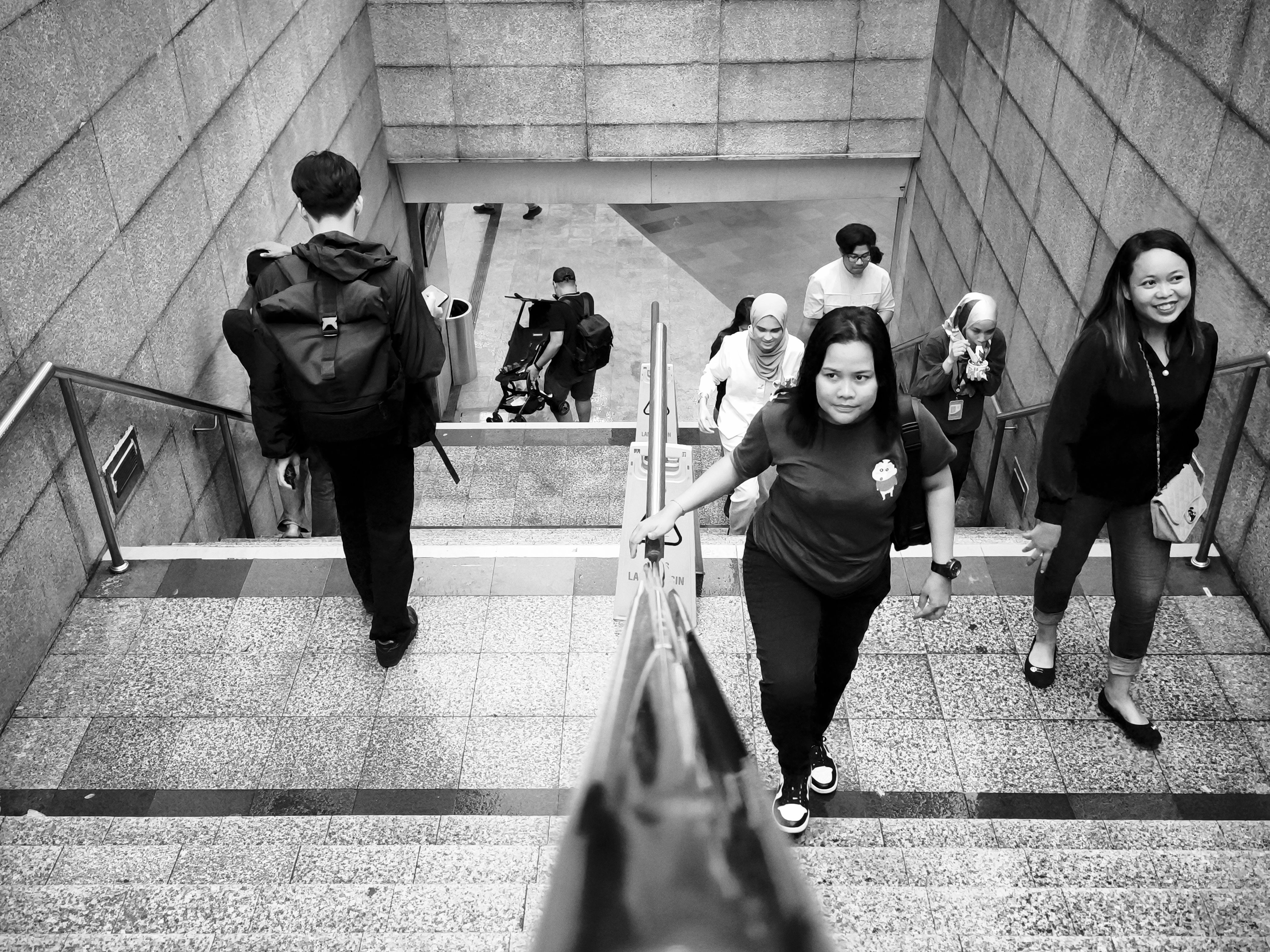 diverse commuters subway stairs