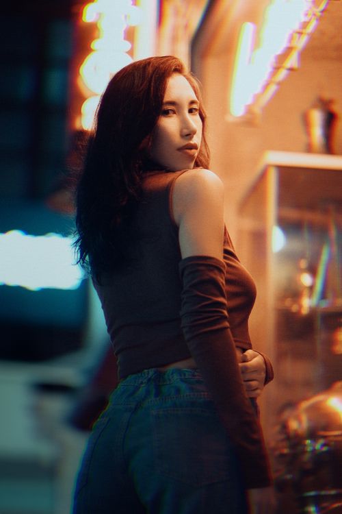 Free A young woman poses in Fethiye, Türkiye, showcasing urban fashion and city night lights. Stock Photo