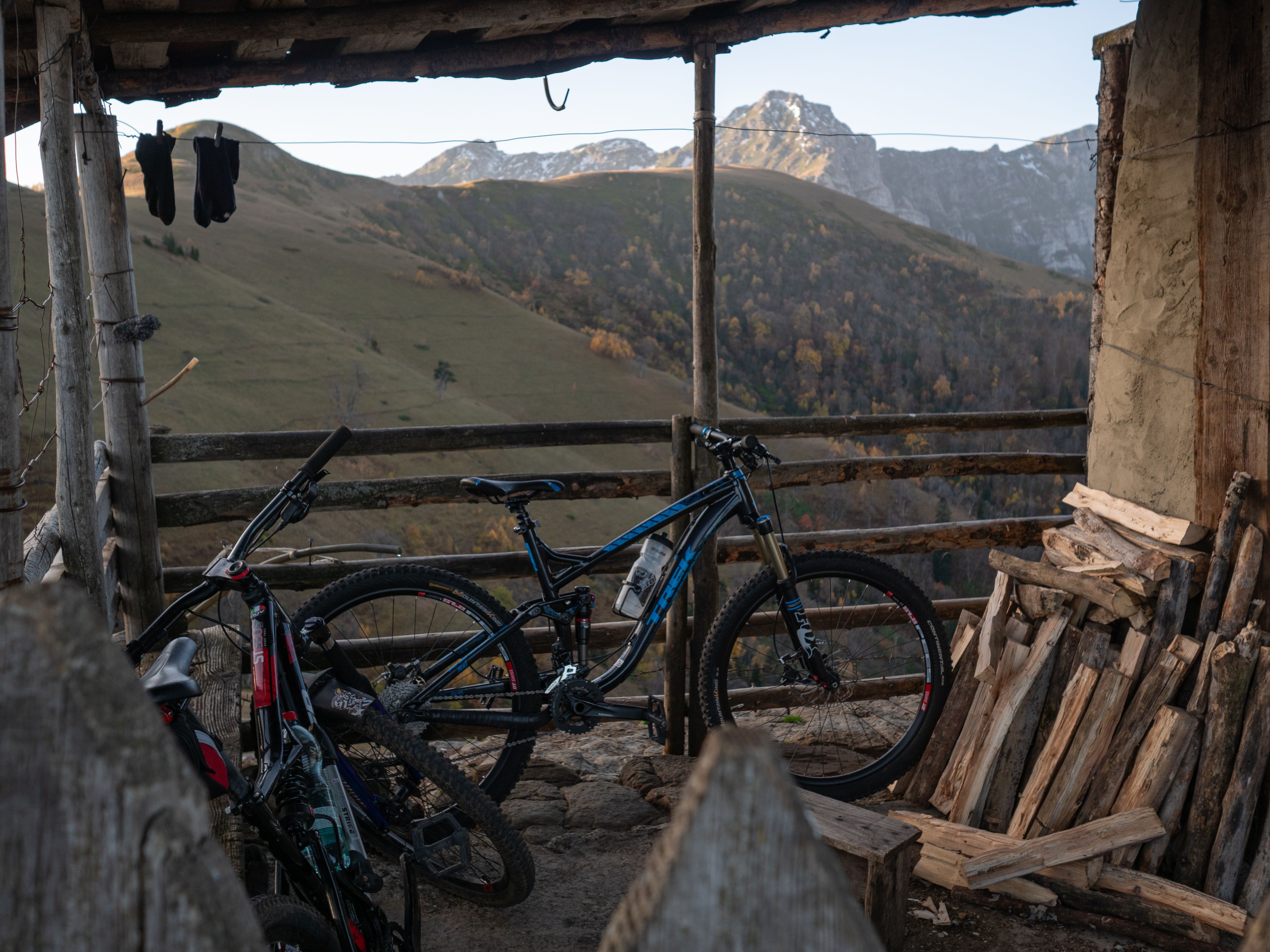 Bicycles parked on a mountain porch overlooking beautiful hills and mountains.