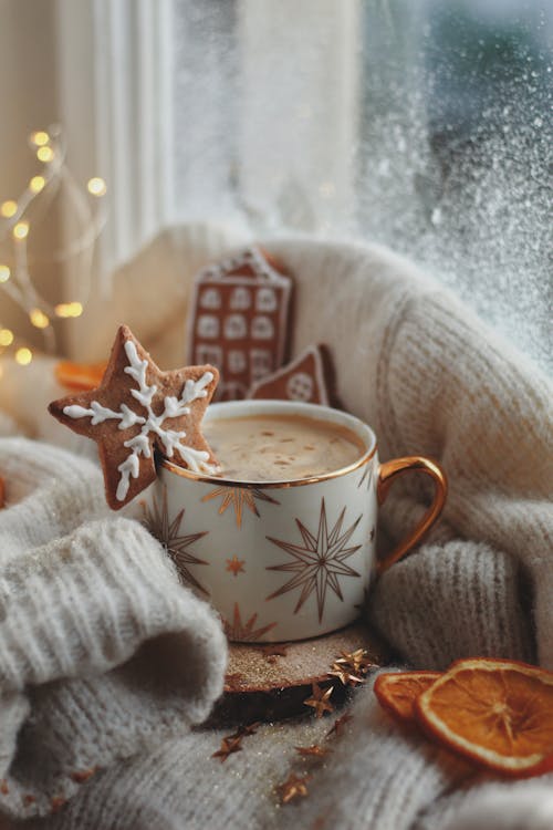 Cup of Hot Chocolate and Christmas Cookies on a Window Sill 