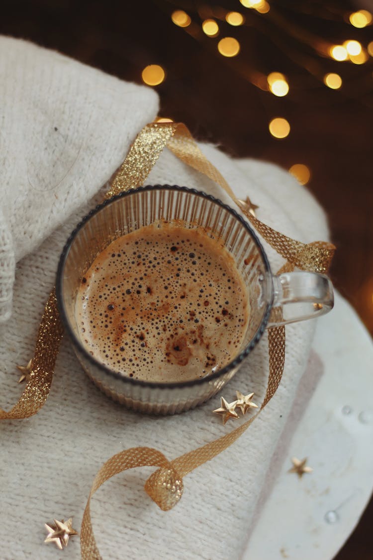 Still Life With A Cup Of Coffee And Golden Christmas Decoration