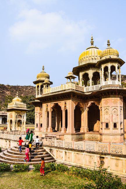 Children explore the historic Gaitor Ki Chhatriyan in Jaipur, showcasing stunning Indian architecture.