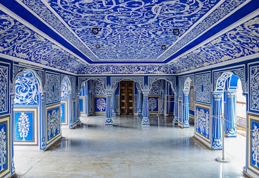 Intricately decorated blue interior of a historic city palace, showcasing vibrant murals and ornate architecture.