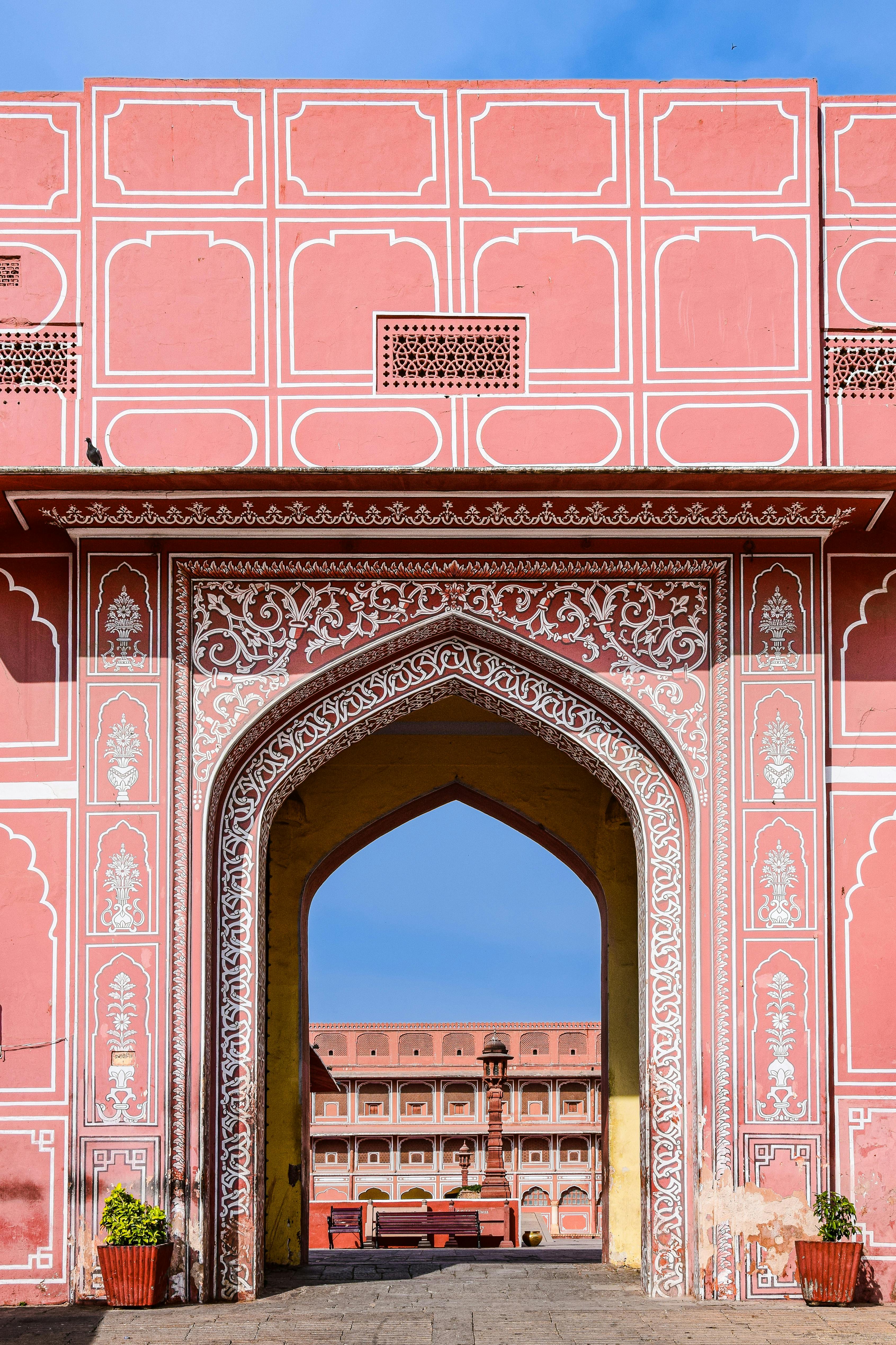 Beautifully detailed archway at a famous Jaipur landmark showcasing traditional Mughal architecture.