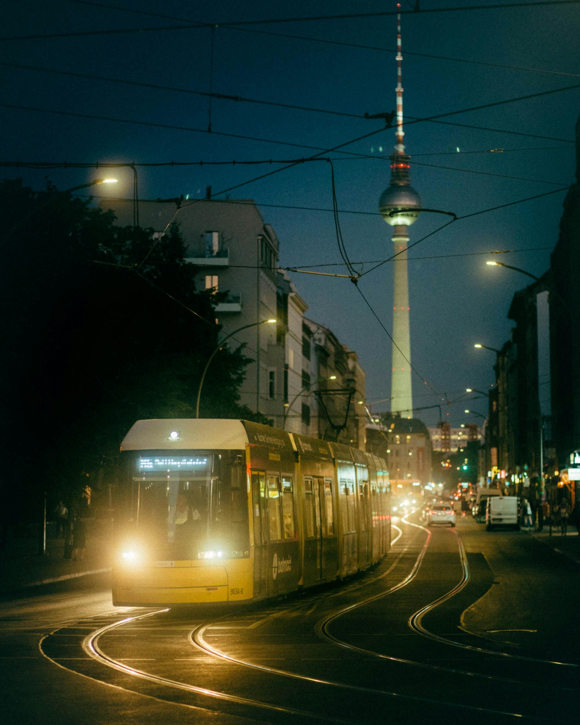 view of a tram and cars on the streets of berlin at night