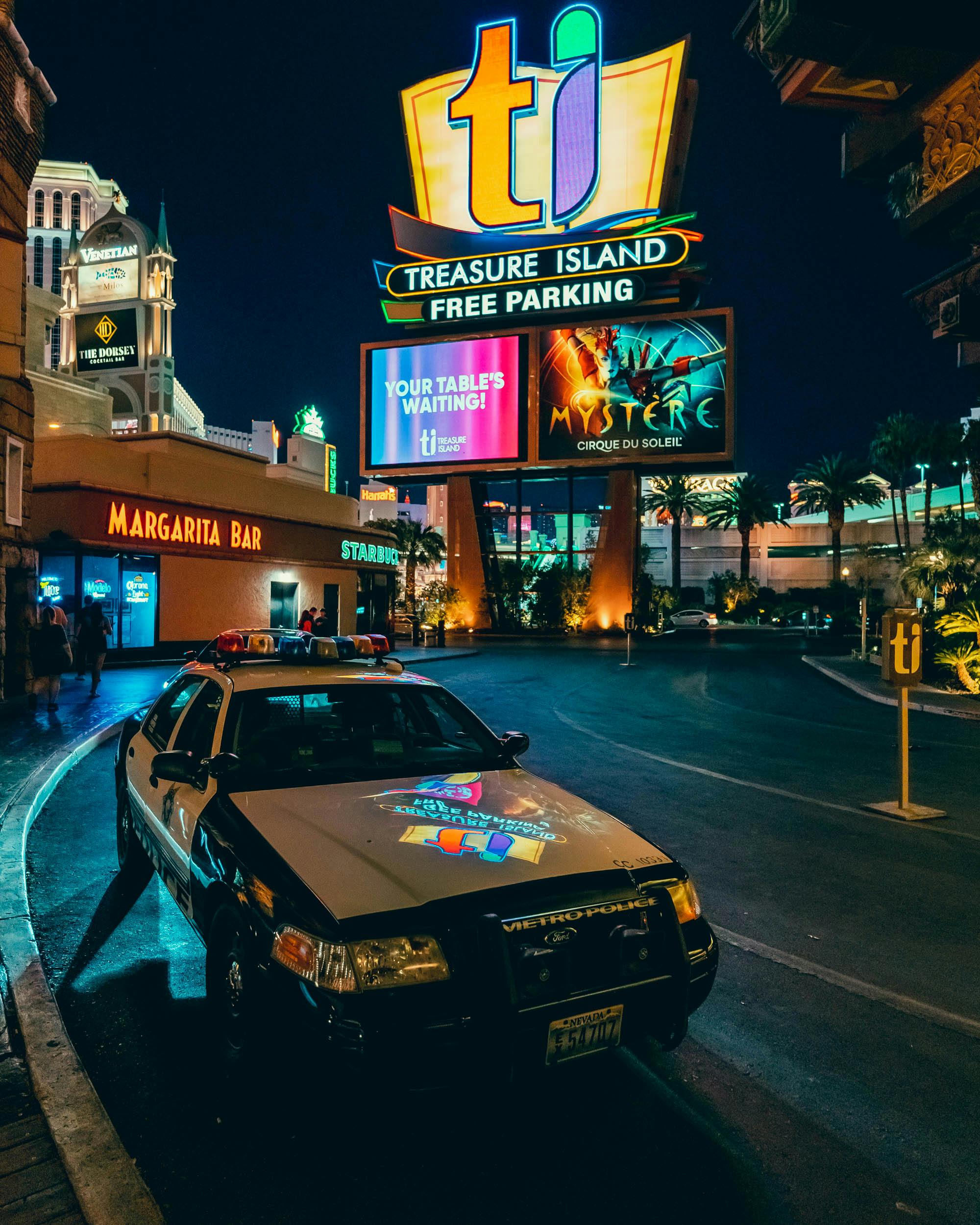 a police car parked on the side of the street in las vegas at night