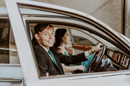 Smiling Couple Sitting in Car