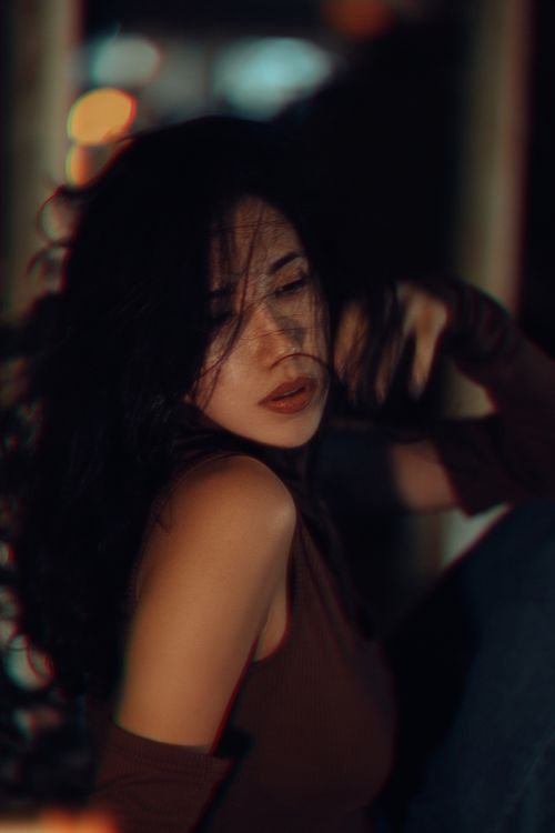 Free Artistic portrait of a young woman sitting in Fethiye, Türkiye, exuding a serene and mysterious vibe. Stock Photo