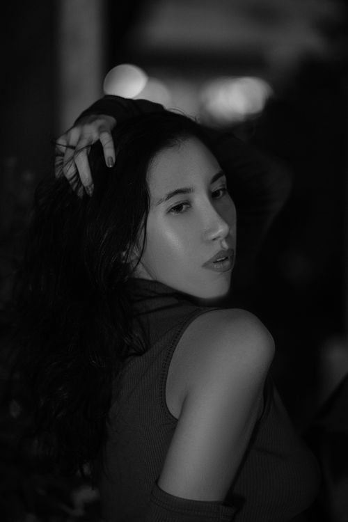 Free Elegant black and white portrait of a young woman with long brunette hair posing. Stock Photo