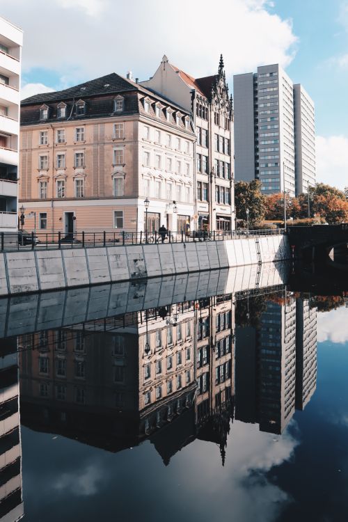 Free Charming blend of urban architecture with autumn reflections on a Berlin river. Stock Photo