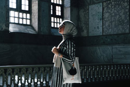 Woman in a Hijab Standing in a Building 