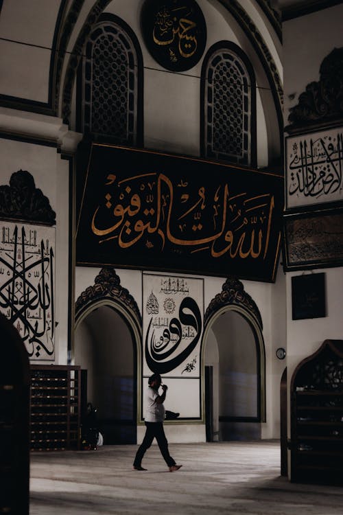 Man Walking Through Entrance Hall of Grand Mosque in Bursa