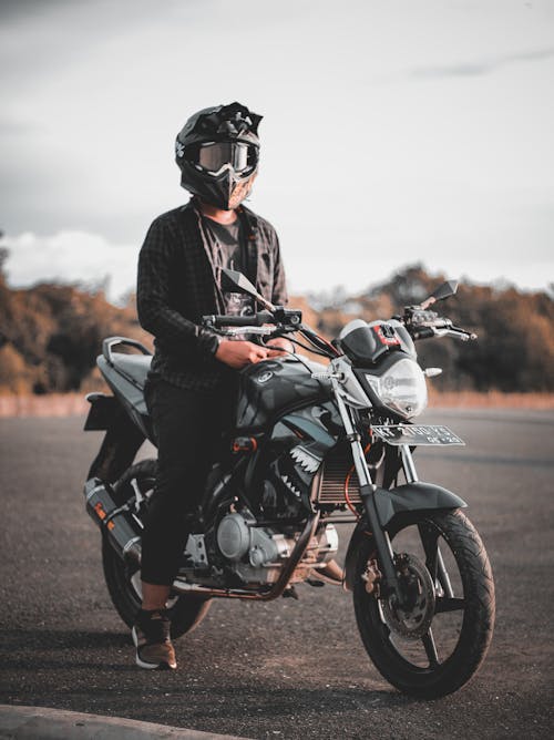 Man Riding Gray Backbone Motorcycle