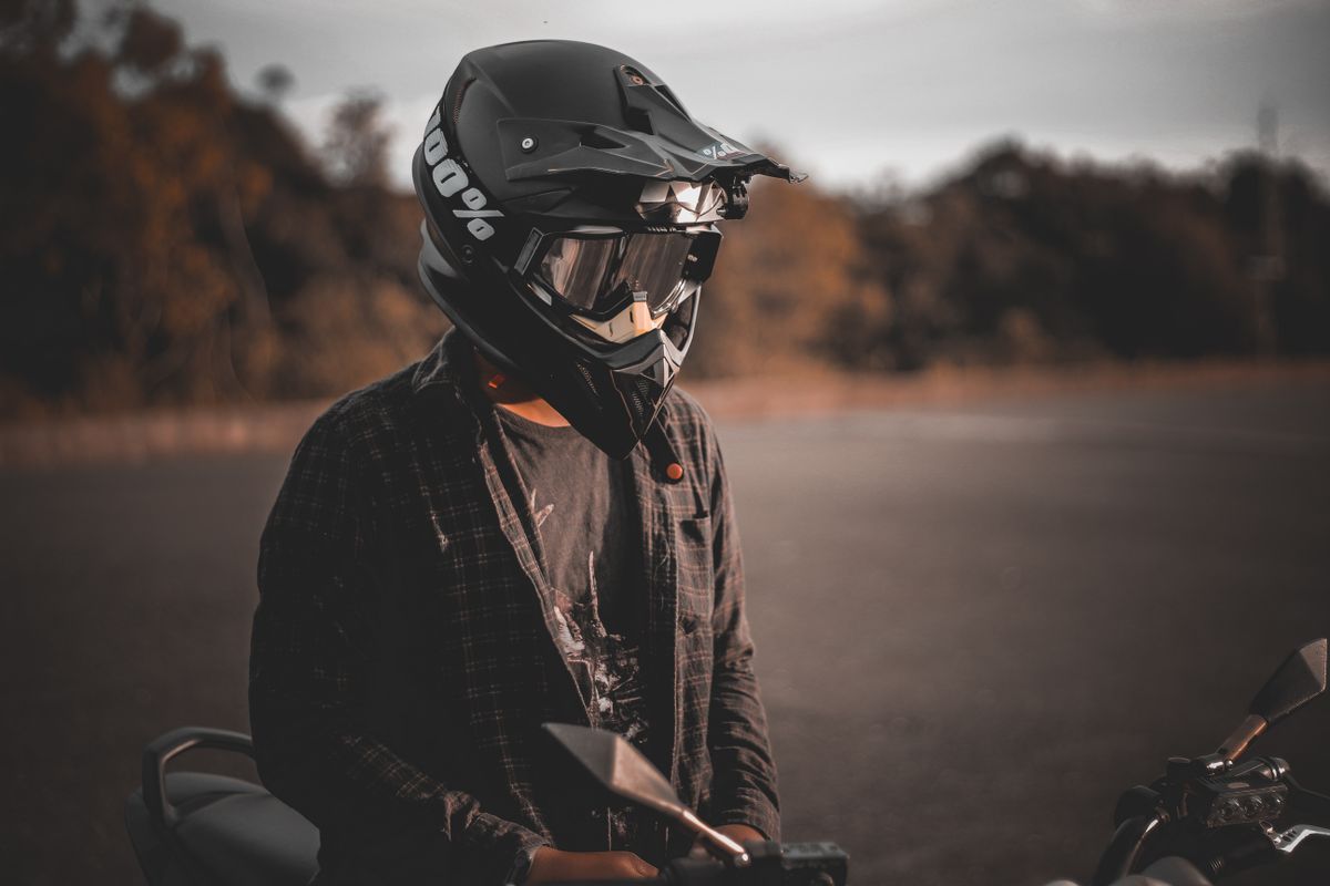 Motorcyclist riding on open road during spring season after completing pre-ride maintenance checklist