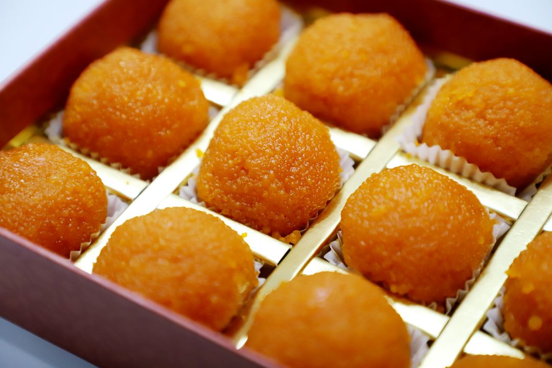 Ganesh Chaturthi 2026: Modak Traditions and Gujarat's Ganeshotsav Food Culture 1 A box of golden boondi laddoos arranged in neat rows, a festival sweet often served alongside modak