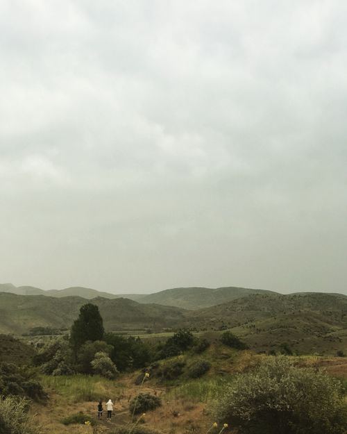 Free Two women walking on a path through the rolling hills near Ankara, Türkiye. Stock Photo