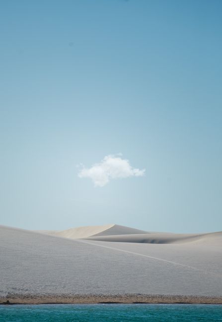 Serene desert dunes under a clear sky with a single cloud, perfect for mobile wallpaper.