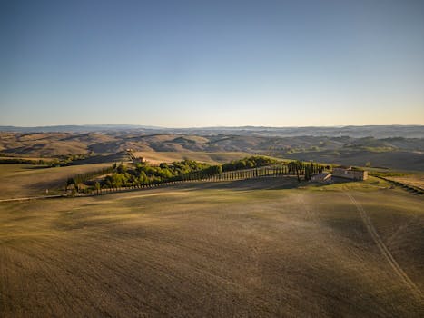 A breathtaking aerial view of the rural landscape in Tuscania, Lazio, Italy with rolling hills and cypress trees.