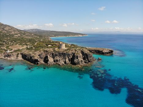 Stunning coastal view of Torre Cannai and crystal blue waters in Sardinia, Italy.