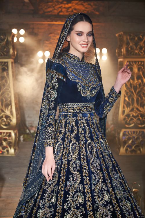Free Stunning traditional blue dress with intricate gold embroidery, perfect for elegant events. Stock Photo