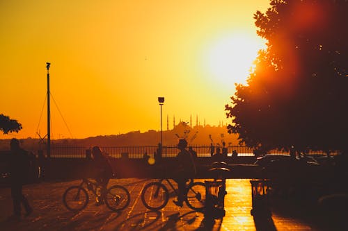 People Riding on Bikes in Istanbul During Sunset