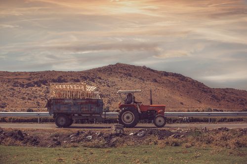 Free Scenic view of a tractor transporting goods in Kayseri's rural landscape under a vibrant sky. Stock Photo