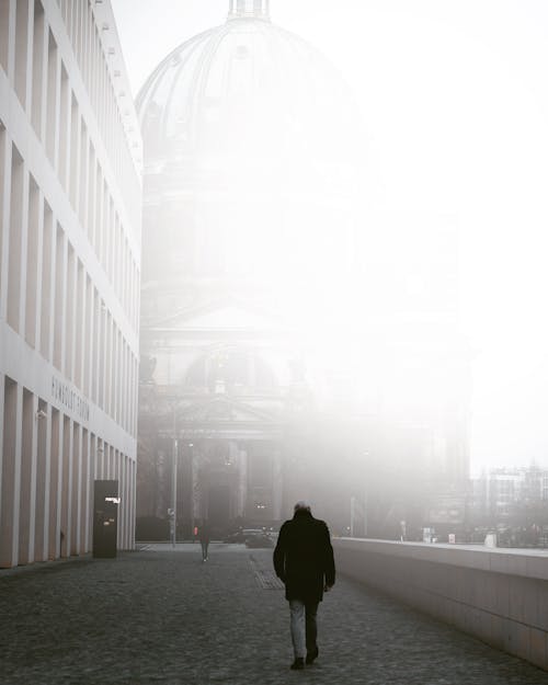 Man Walking on Foggy Day