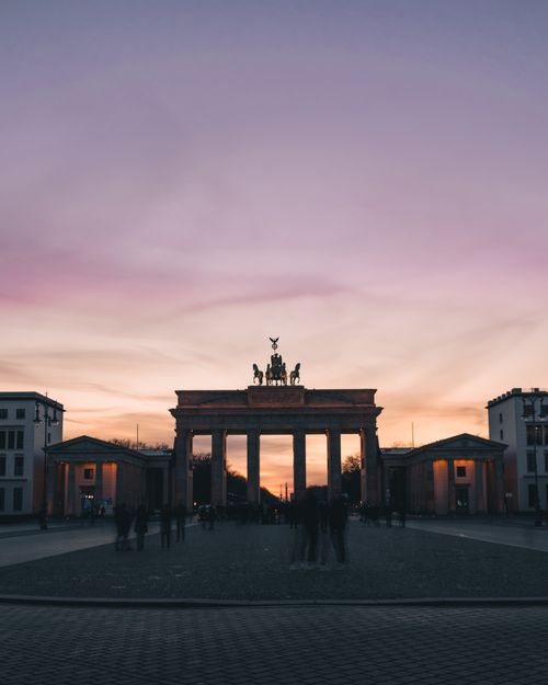 Free Iconic neoclassical Brandenburg Gate under a stunning twilight sky in Berlin, Germany. Stock Photo
