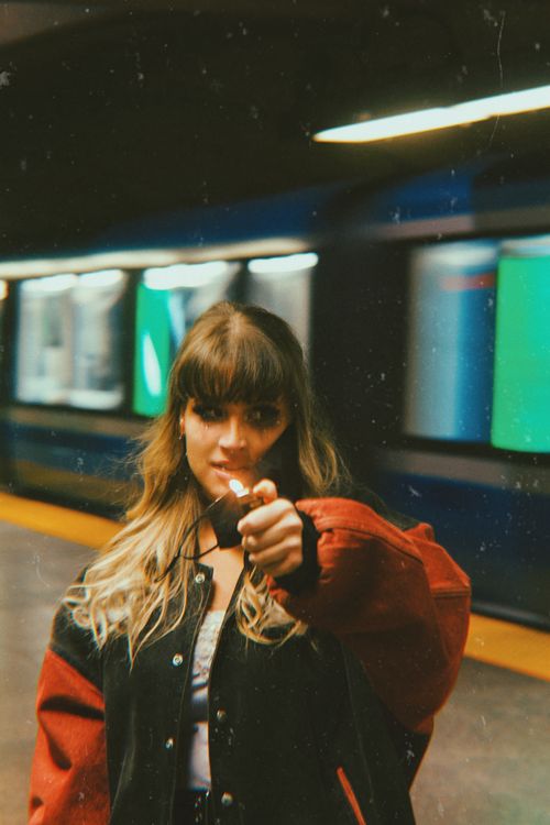 Free Artistic portrait of a young woman in a metro station with a vintage touch. Stock Photo