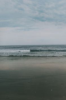 Serene ocean waves with a cloudy sky, capturing a peaceful coastal scene.