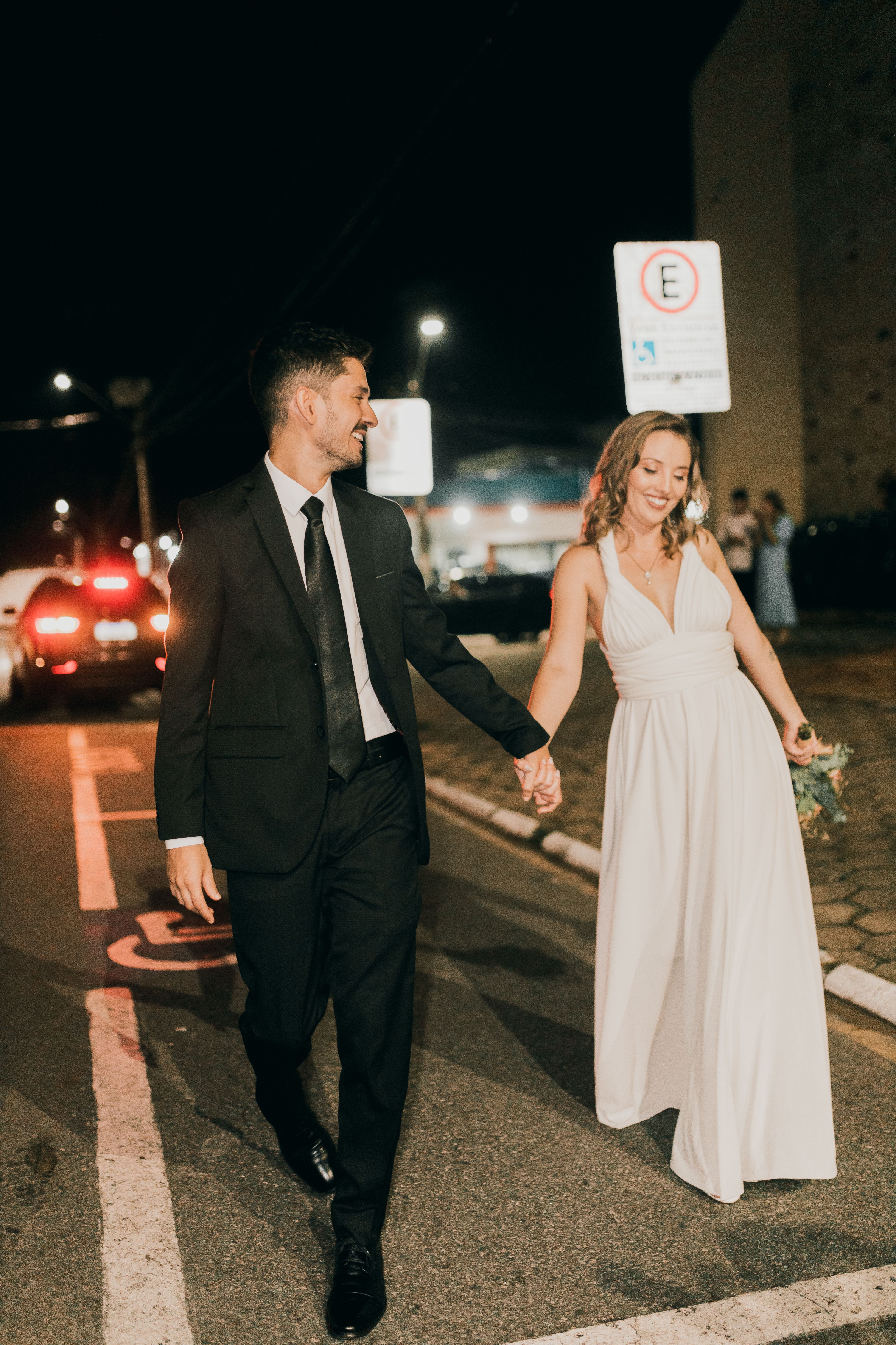 Couple walking together on a city street in the evening