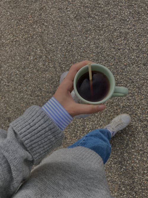 Person Holding Tea in Green Mug