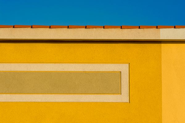 Yellow facade against a blue sky — photo by Jan van der Wolf on Pexels