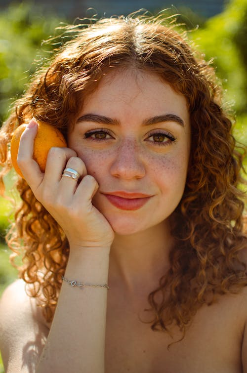 Portrait of Brunette Woman Holding an Orange 