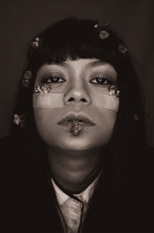 Portrait of Woman with Flowers on Her Face in Black and White