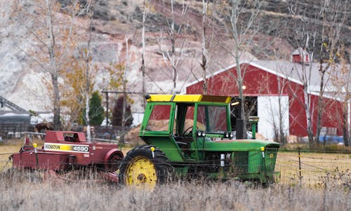 John Deere Tractor with Machine on Field